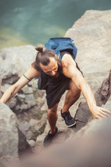 Climber man on high hill