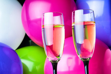 Two glasses of champagne and balloons on party