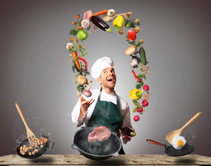 Chef juggling with vegetables and other food in the kitchen