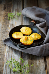 Peaches in caramel on a hot frying pan