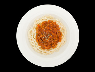 Spaghetti bolognese with pork or meat tomato sauce on a plate isolated on the black background with clipping path