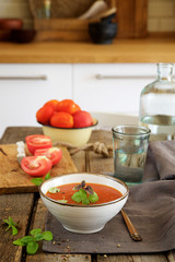 Tomato soup on a wooden table in the kitchen