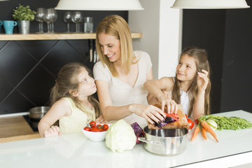 Mother and daughters in the kitchen
