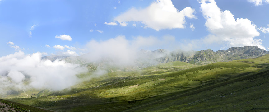 beautiful traditional plateau life and green nature on the mountains with fog