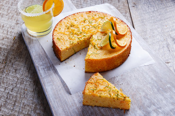 Home made whole testy orange cake on a wooden surface