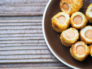 Bread sausage with cheese roll on the brown plate for enjoy tea break