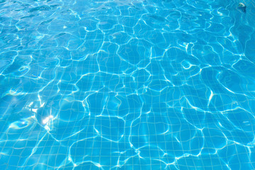 Fototapeta na wymiar Beautiful water surface in swimming pool with sun reflection