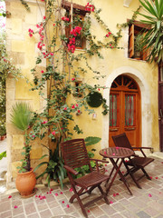 traditional street among bougainvillaea in rethymno city Greece