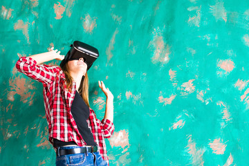 girl getting experience using VR-headset glasses of virtual reality gesticulating hands