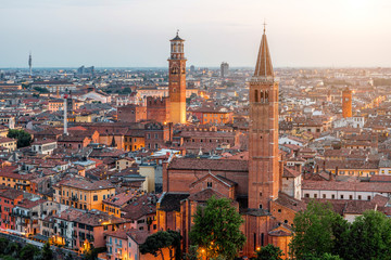 Fototapeta na wymiar Verona aerial view on illuminated old town on the sunset in Italy