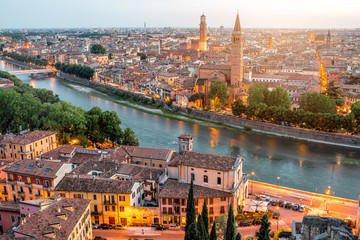 Verona panoramic aerial view on illuminated old town on the sunset in Italy - obrazy, fototapety, plakaty
