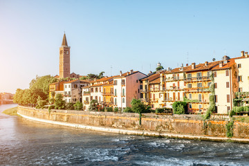 Verona cityscape view on the riverside with historical buildings and tower on the sunrise - obrazy, fototapety, plakaty