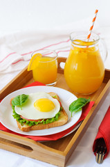 Toast with fried egg, and orange juice