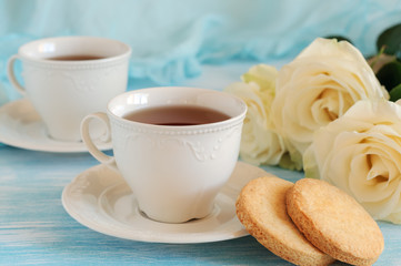 Fototapeta na wymiar Tea in elegant porcelain cups and shortbread