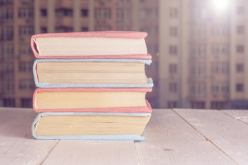 Books in the window with city view. Copy space for text