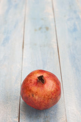 Pomegranate on a blue wooden board