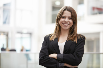 Fototapeta premium Head And Shoulders Portrait Of Young Businesswoman In Office