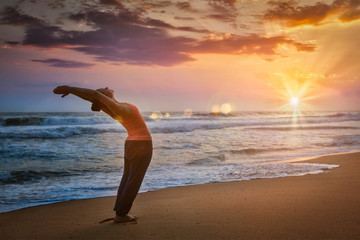 Fototapeta na wymiar Young sporty fit man doing yoga Sun salutation Surya Namaskar
