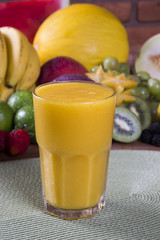 Glasses of juice with fresh fruits for summer