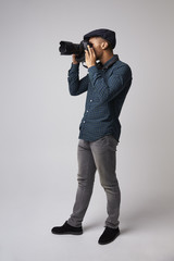 Studio Portrait Of Male Photographer With Camera