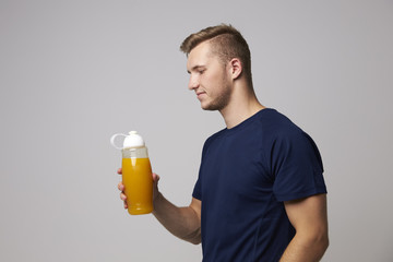 Fototapeta premium Studio Portrait Of Male Nutritionist With Drinks Bottle