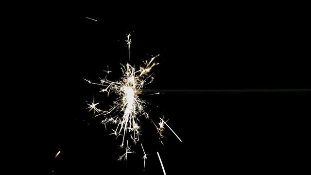 A burning fuse or bengal fire. Isolated on black. Shiny sparkles.
