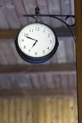 Vintage clock at antique train station. Western movies topic