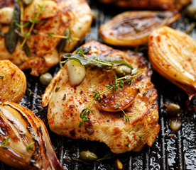 Grilled turkey fillet with addition of herbs, spices  and vegetables on the grill 