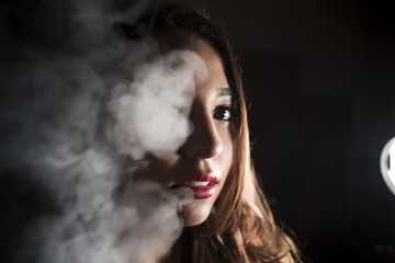 Portrait of a girl through smoke