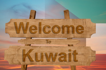 Welcome to Kuwait sign on wood background with blending national flag