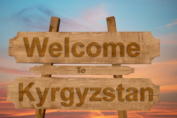 Welcome to Kyrgyzstan sign on wood background