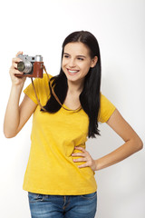Young Woman Holding retrocamera against white background