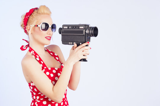 Pin-up girl holding vintage 8mm camera