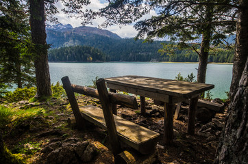 Wooden table on the shore of Black Lake in Montenegro