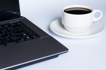 Obraz na płótnie Canvas Laptop and coffee cup on white