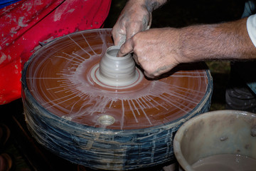 Potter behind work