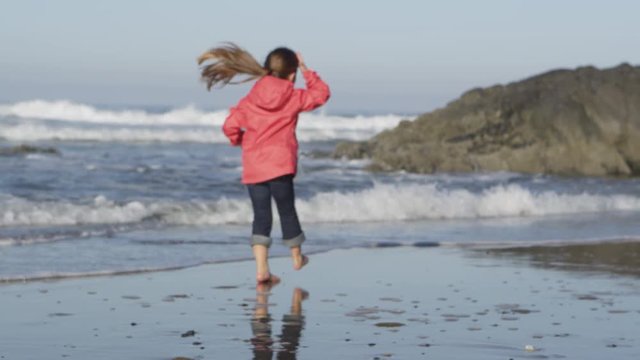 Young girl on the beach - 4K