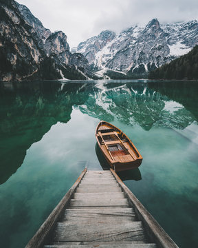 Mountain reflected in water with boat and stairway 