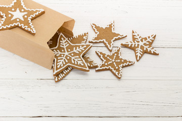 Gingerbread cookies in a packing pag on a white wooden backgroun