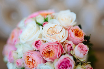 Wedding rings on a bouquet of roses, close-up