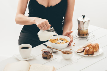 Woman having breakfast. Window light
