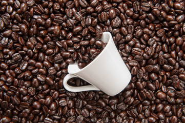 Coffee mug on coffee beans.