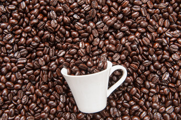 Coffee mug on coffee beans.
