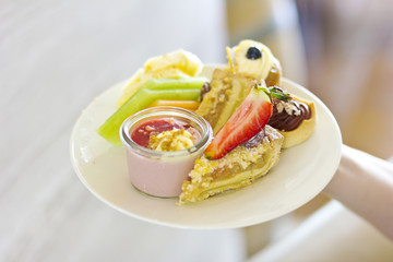 Dessert on a plate. Delicious sweet dessert. Refreshments. Souffle and cakes on a white plate
