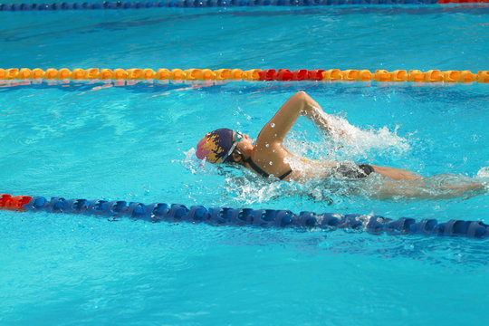 Asian girl swimmer practice forward crawl swimming stroke in a swimming pool for race