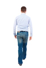 Back view of walking businessman. Bearded businessman in a white shirt out of the frame.