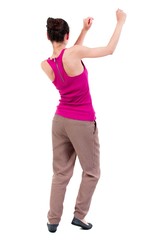 back view of dancing young beautiful woman. dark-skinned girl in a red shirt is engaged in aerobics.