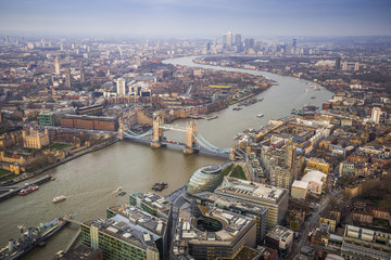 London, England - Aerial Skyline view of London with the iconic Tower Bridge, Tower of London and skyscrapers of Canary Wharf at dusk