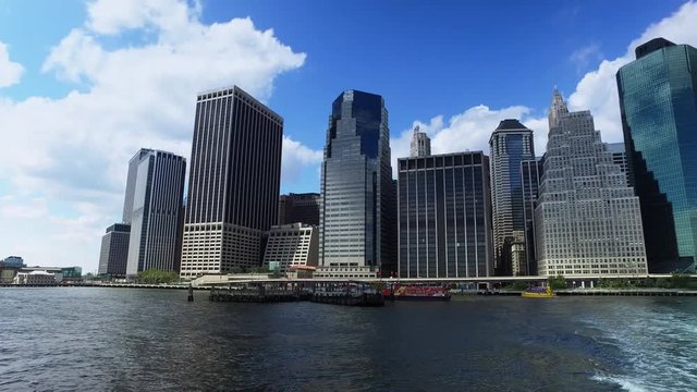 A daytime establishing shot of the lower Manhattan skyline as seen from the East River Ferry.  	