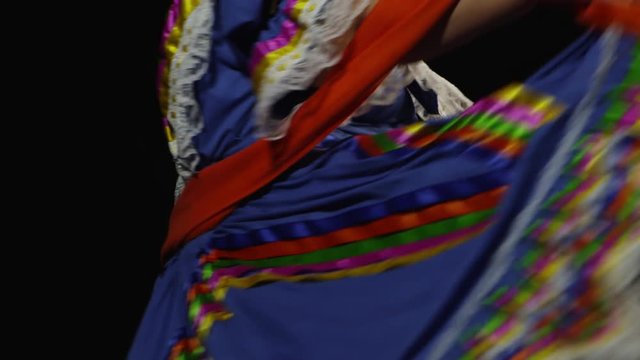 Slow motion shot of Mexican women in traditional dress dancing in the dark - 4K